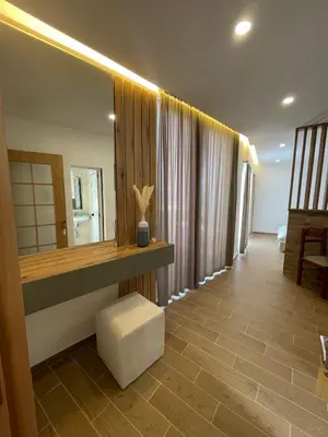 a bathroom with a counter and a mirror and a stool at Apartments Basha 1 - Long Beach in Ulcinj