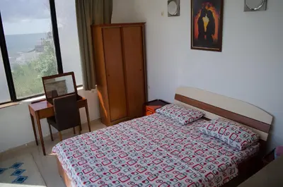a bedroom with a bed and a desk and a window at Apartments Basha 1 - Long Beach in Ulcinj