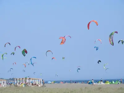 a bunch of kites flying in the sky on a beach at Apartments Basha 1 - Long Beach in Ulcinj