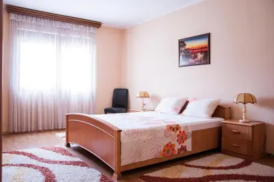a bedroom with a large bed and a window at Apartments Rudovic in Ulcinj