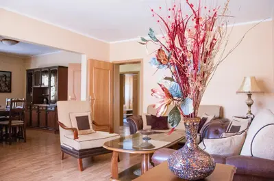 a living room with a vase with flowers on a table at Apartments Rudovic in Ulcinj