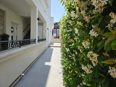 a walkway with flowers on a building at Marini Casa in Ulcinj