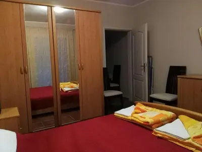 a bedroom with two beds and a mirror at Apartmani Cuce in Kotor