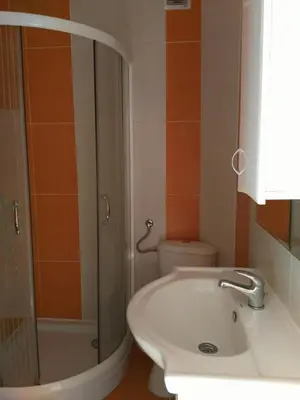 a bathroom with a toilet and a sink and a shower at Apartmani Cuce in Kotor