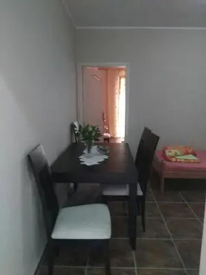 a dining room with a table and chairs and a window at Apartmani Cuce in Kotor