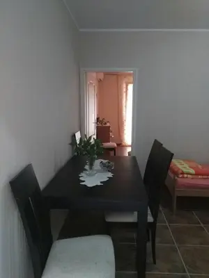 a dining room with a black table and chairs at Apartmani Cuce in Kotor