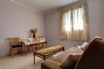 a living room with a couch and a table at Do Re Mi Apartments in Budva