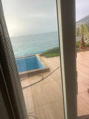 a view of the ocean from a sliding glass door at Resort Stikovic in Dobra Voda