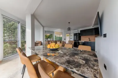 a kitchen with a table with a bowl of fruit on it at Resort Stikovic in Dobra Voda
