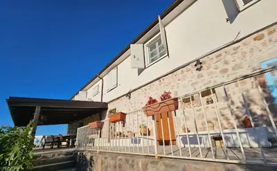 a building with a mural on the side of it at Dembelija Rooms in Virpazar