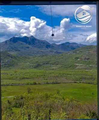 a view of a field with mountains in the background at Dembelija Rooms in Virpazar