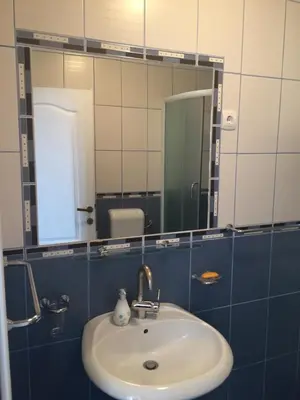 a bathroom with a sink and a mirror at Apartments Bonaca in Budva