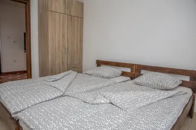 a bedroom with two twin beds with pillows at Apartments Bonaca in Budva