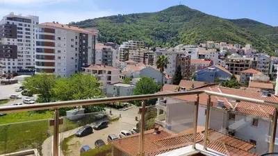 a view of a city with a mountain in the background at Apartment Adrialux in Budva