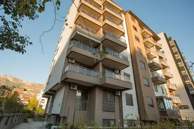 an apartment building with balconies on the side of it at Apartment Adrialux in Budva