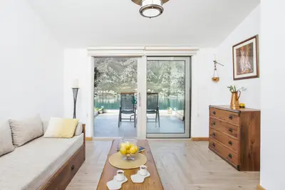 a living room with a couch and a table at De Lux Apartments Sirena in Kotor