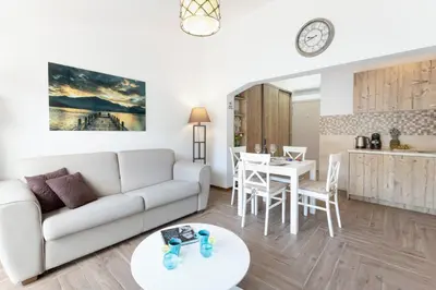 a living room with a white couch and a table at De Lux Apartments Sirena in Kotor