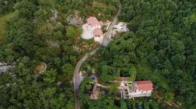 an aerial view of a house in the woods at centuries old Ethno House Đurović in Virpazar