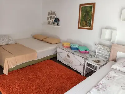 a bedroom with a bed and a table and a chair at centuries old Ethno House Đurović in Virpazar
