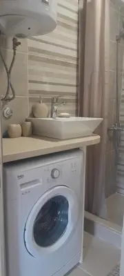 a bathroom with a washing machine and a sink at centuries old Ethno House Đurović in Virpazar