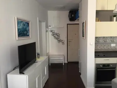 a living room with a flat screen tv on a white cabinet at Squere 44 Apartment in Budva