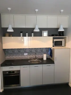a kitchen with a sink and a microwave at Squere 44 Apartment in Budva