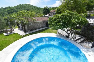 a large blue swimming pool in a yard at GRANDFATHER'S Secret in Danilovgrad