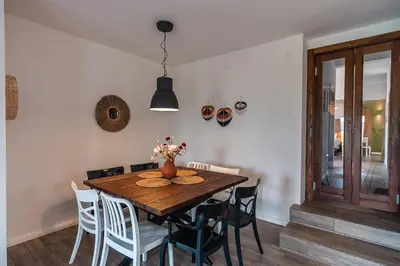 a dining room with a wooden table and chairs at GRANDFATHER'S Secret in Danilovgrad