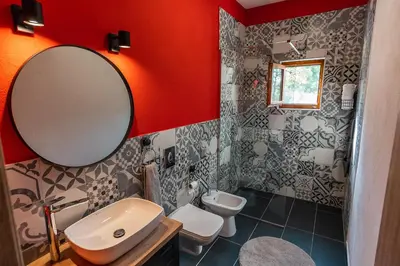 a bathroom with a sink and a mirror and a toilet at GRANDFATHER'S Secret in Danilovgrad