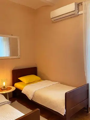 a bedroom with two beds and a air conditioner at S&I room in Kotor