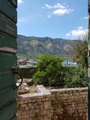 a view from the side of a building with mountains in the background at S&I room in Kotor