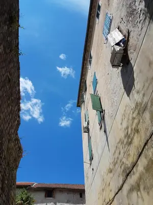 a view of the sky from between two buildings at S&I room in Kotor