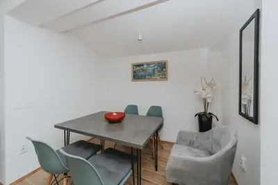 a dining room with a table and chairs at Panoramic Apartment in Budva