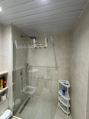 a bathroom with a shower with a glass door at Apartmani Bulevar in Budva