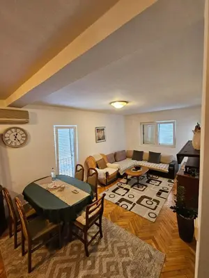 a living room with a table and a couch at Apartmani Bulevar in Budva