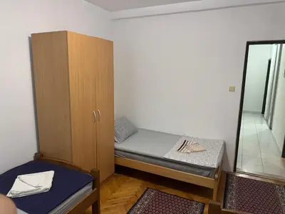 a small room with a bunk bed and a mirror at Apartmani Bulevar in Budva