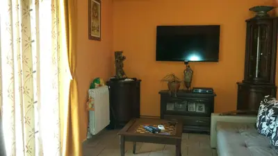 a living room with a couch and a tv on the wall at Sole Apartments in Kotor