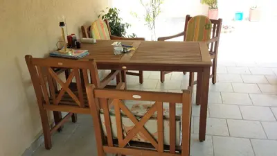 a wooden table and chairs in a room at Sole Apartments in Kotor