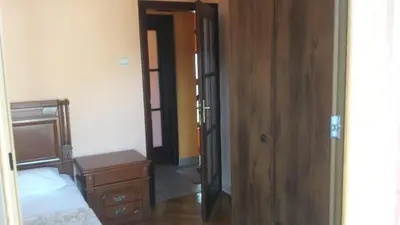 a bedroom with a bed and a wooden door at Sole Apartments in Kotor