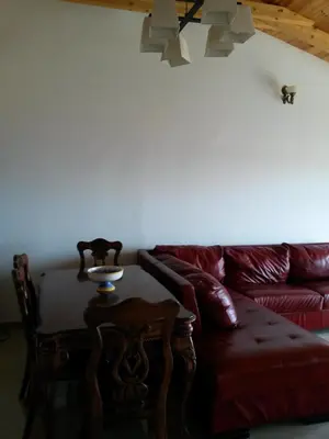 a living room with a red couch and a table at De Luxe Apartment with a Seaview in Petrovac na Moru