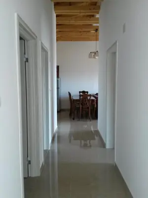 a hallway with a table and a dining room at De Luxe Apartment with a Seaview in Petrovac na Moru