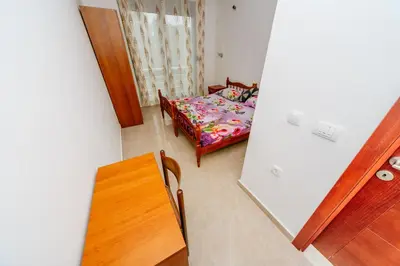a small room with a table and a bed at Teuta Apartments in Ulcinj