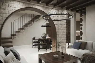 a living room with a spiral staircase and a table at Kulla e Balshajve in Ulcinj