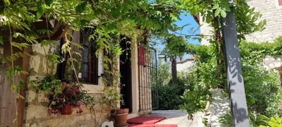 an entrance to a house with trees and plants at Hotel Palata Venezia in Ulcinj