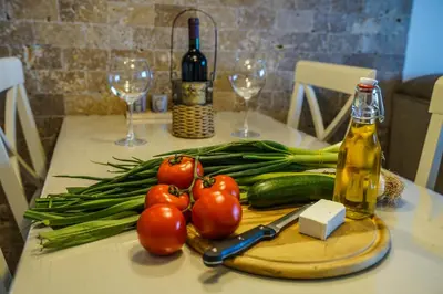 a table with tomatoes and vegetables on a cutting board at Apartments Bazar in Ulcinj