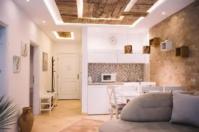 a kitchen and living room with a couch and a table at Apartments Bazar in Ulcinj