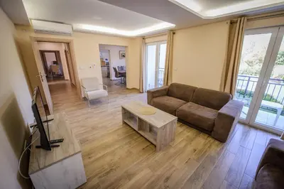 a living room with a couch and a table at Apartment Vrutak in Kotor