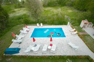an overhead view of a swimming pool with chairs at Apartment Vrutak in Kotor