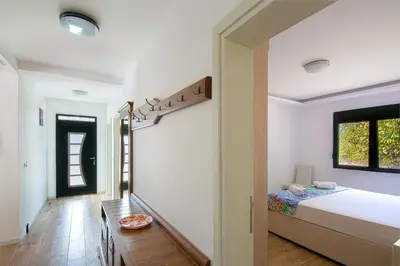 a bedroom with a bed and a table at Villa Latina 2 in Budva