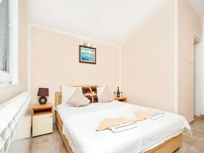 a white bedroom with a bed and a window at Apartments MIK5 - Famous Beach Jaz in Budva